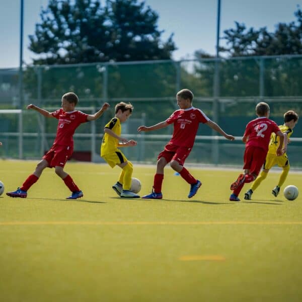 group of men playing soccer during daytime