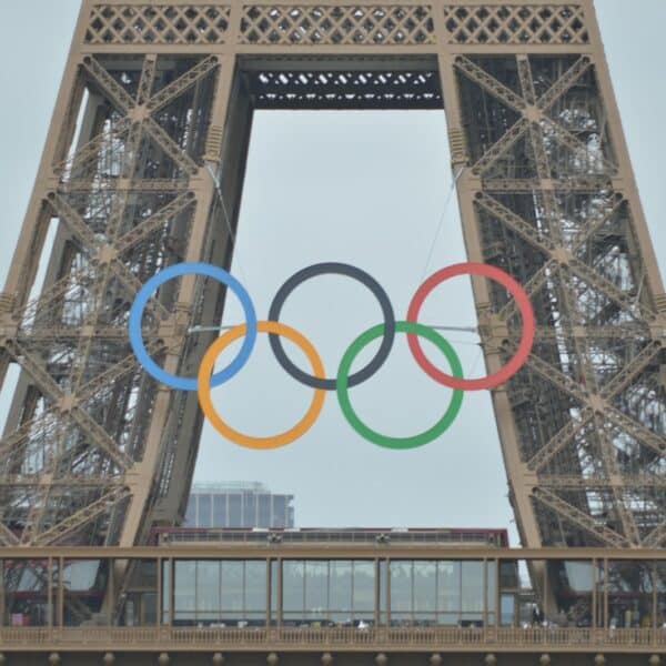 The olympic rings are on top of the eiffel tower