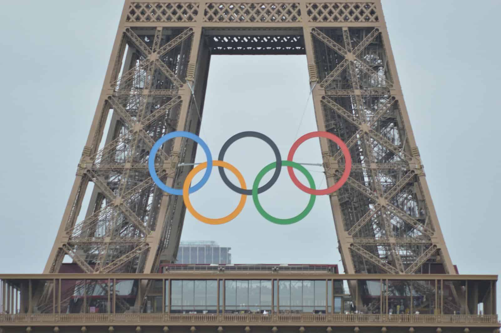 The olympic rings are on top of the eiffel tower